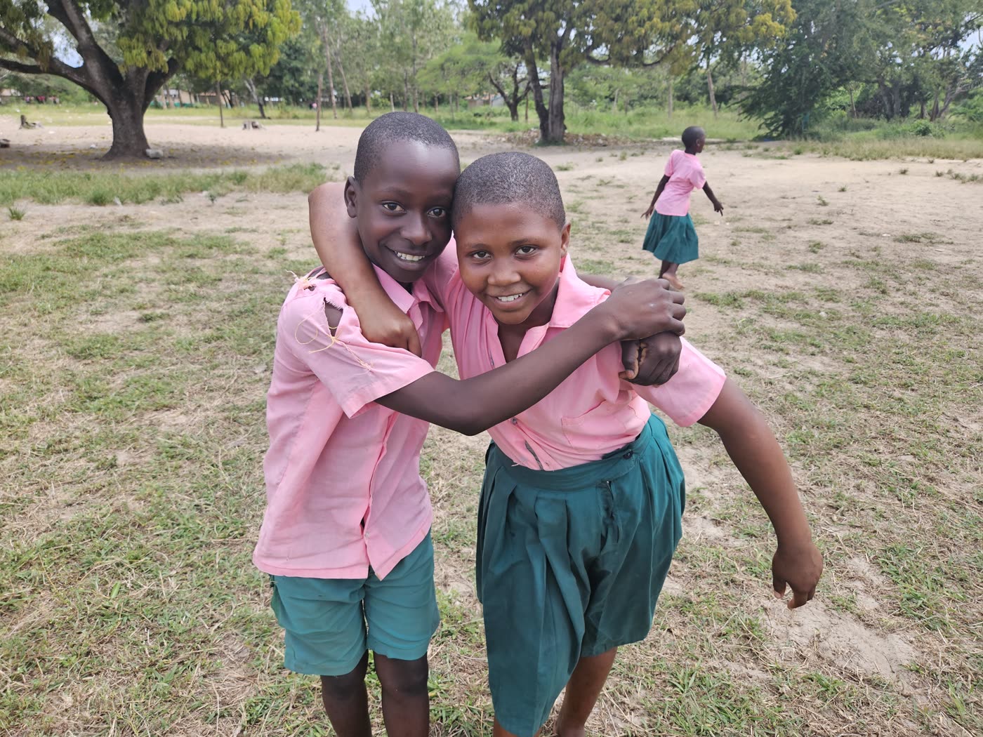 Two students hugging in the schoolyard