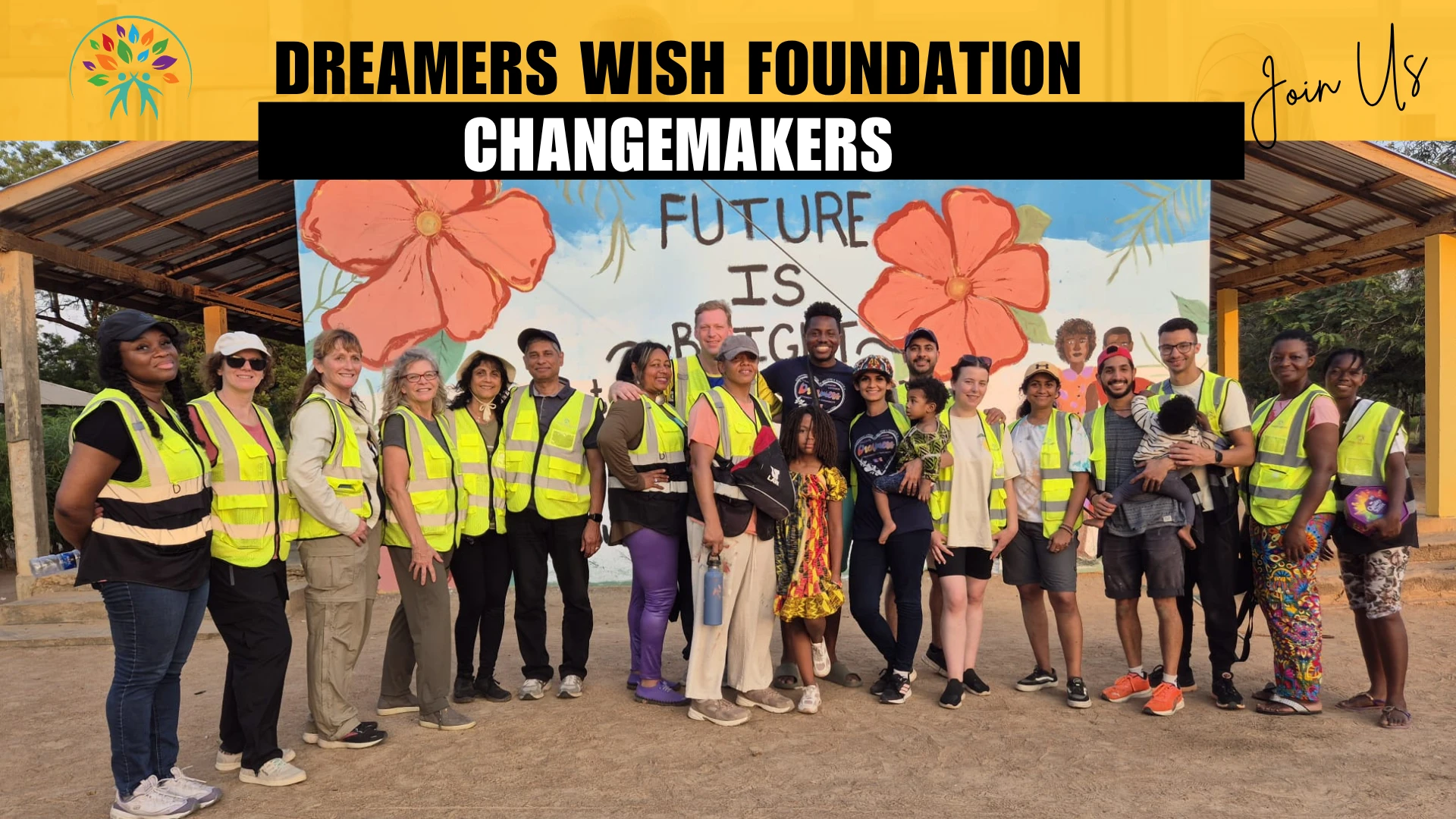 Dreamers Wish Foundation changemakers: a big group of volunteers in front of the Our Future Is Bright mural in Dadome, Ghana