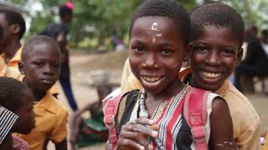 Students smiling at a partner school in Ghana