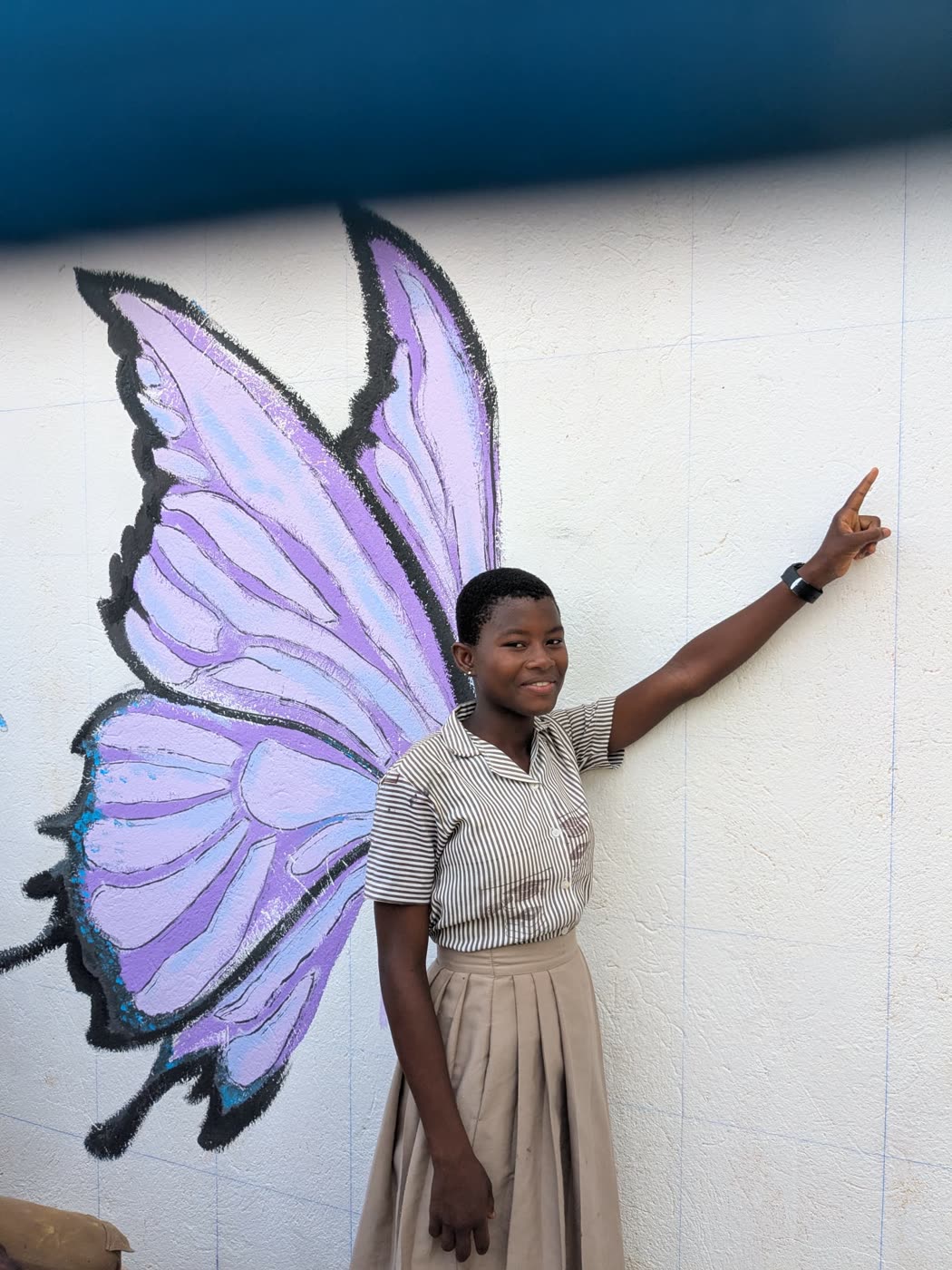 A girl posing with painted butterfly wings