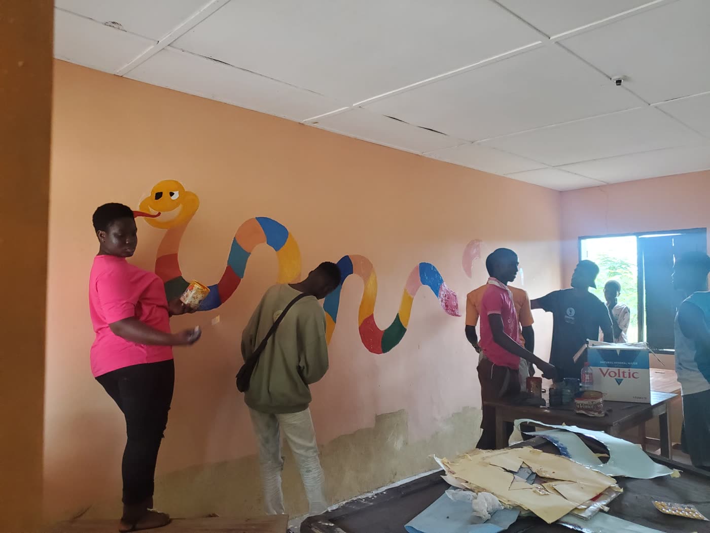 Volunteers painting inside a classroom