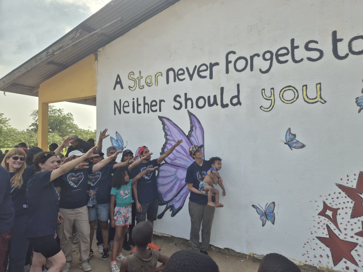 The whole school celebrating in front of the finished mural