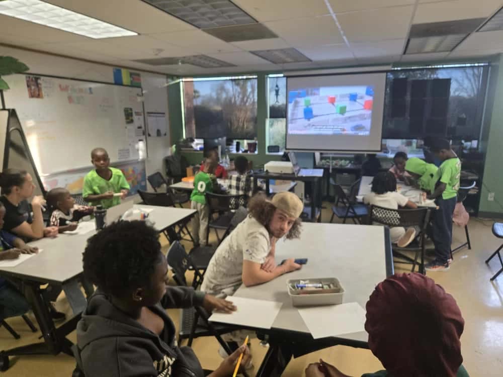 Volunteers and instructors teaching a full robotics class in Utah