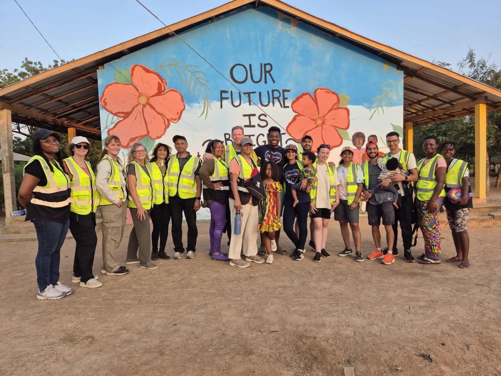 Volunteers with a finished mural at a partner school